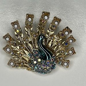 Gold tone AB and pearl peacock brooch.
